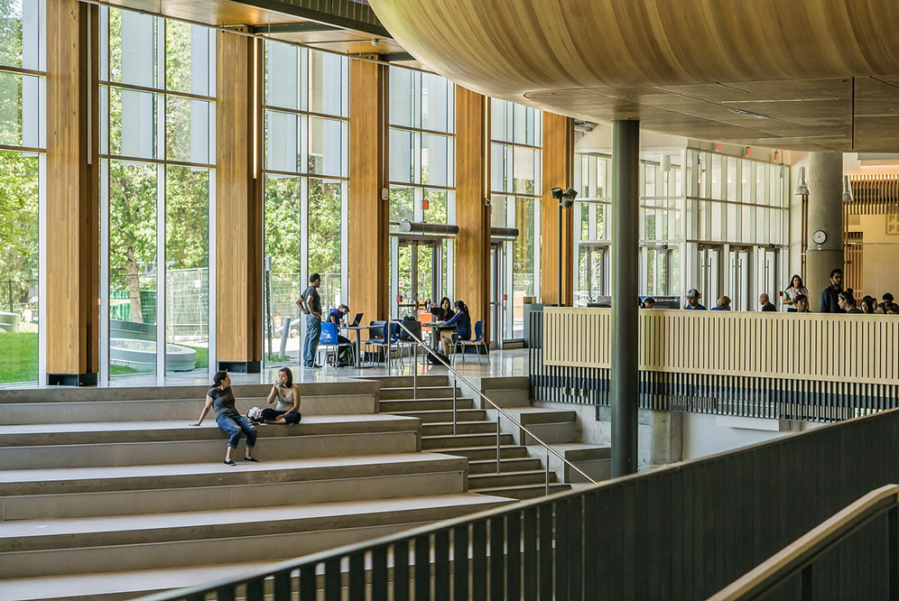 University building with students launging on stairs